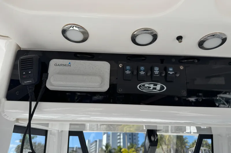 Slide: The Image of 2022 Sea Hunt Gamefish 25 dashboard with Garmin device and control panel. - 25