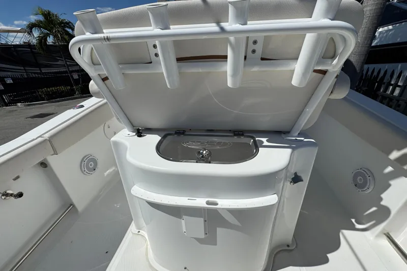 Slide: The Image of 2022 Sea Hunt Gamefish 25 boat interior with rod holders and storage compartment. - 4