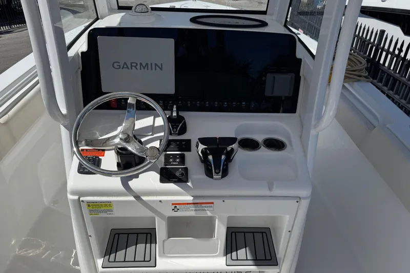 Slide: The Image of 2022 Sea Hunt Gamefish 25 helm with Garmin display and steering wheel. - 7