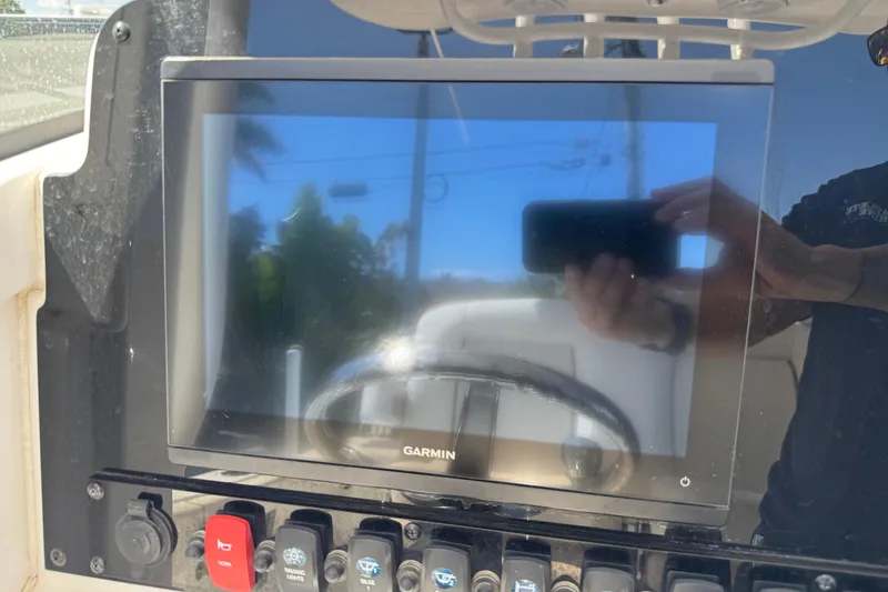 Slide: The Image of Garmin display on 2022 Sea Hunt Gamefish 25 boat dashboard with control switches. - 8