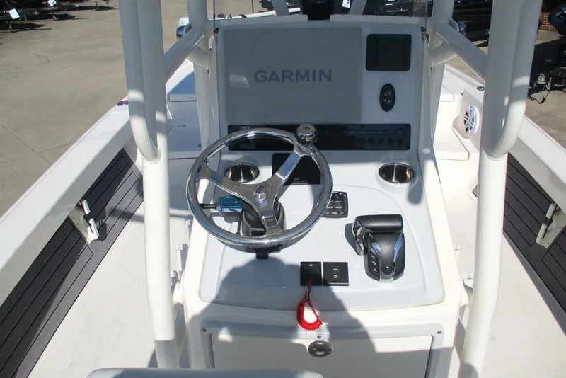 Slide: The Image of 2023 Custom Pathfinder 2500 boat console with Garmin navigation system and steering wheel. - 9