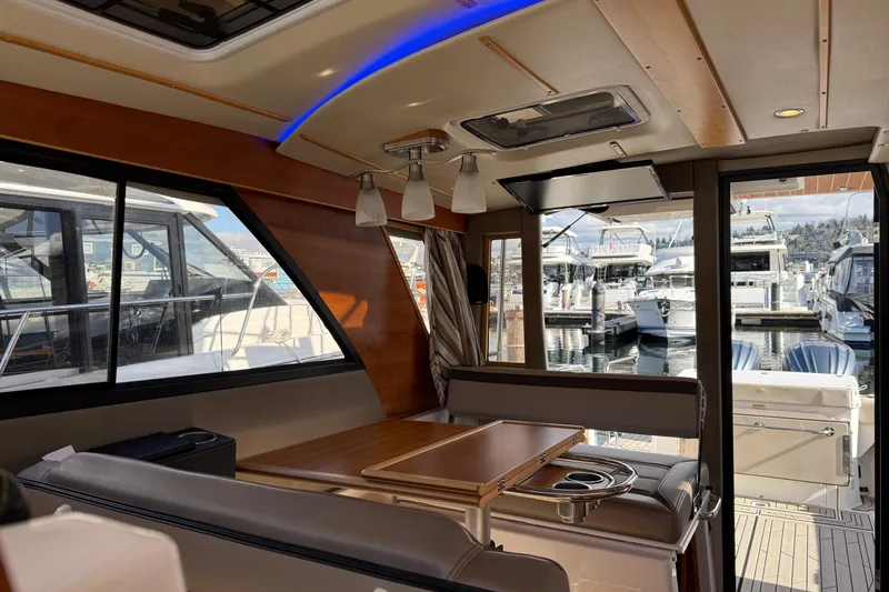Slide: The Image of Interior of 2022 Cutwater C-32 CB yacht with modern seating and marina view. - 12