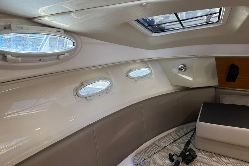 Slide: The Image of 2022 Cutwater C-32 CB cabin interior with portholes and seating area. - 15