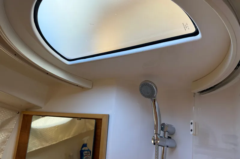 Slide: The Image of Interior of 2022 Cutwater C-32 CB boat bathroom with skylight and showerhead. - 19