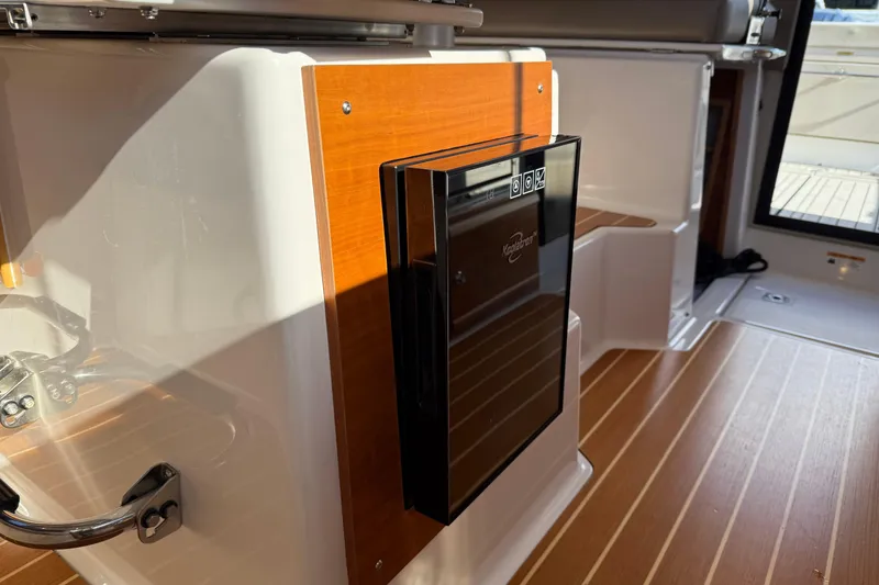 Slide: The Image of 2022 Cutwater C-32 CB interior with wood paneling and built-in Kenyon grill. - 21