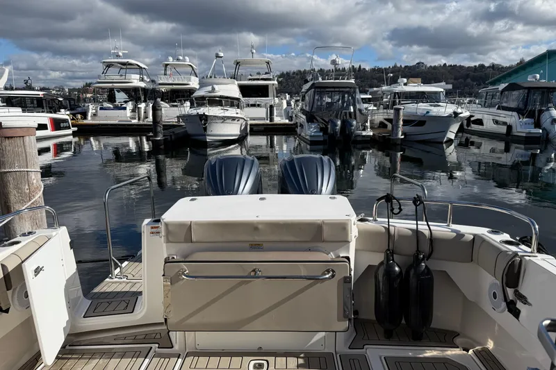 Slide: The Image of 2022 Cutwater C-32 CB boat docked in a marina with other vessels. - 24