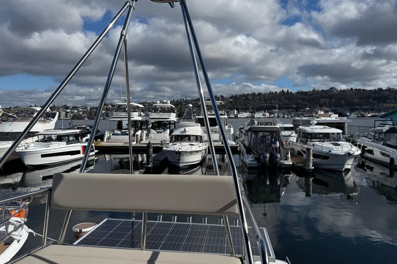 Slide: The Image of Marina view from 2022 Cutwater C-32 CB boat, showcasing docked vessels under cloudy sky. - 28