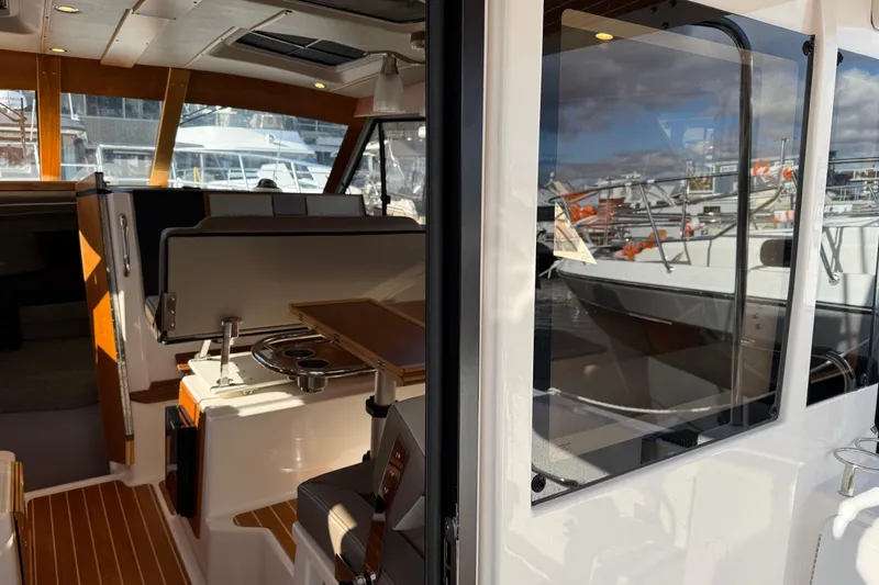 Slide: The Image of Interior view of 2022 Cutwater C-32 CB boat, showcasing seating and table setup. - 5