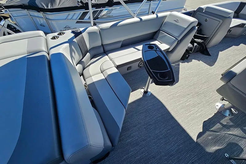 Slide: The Image of 2026 SunCatcher Select 22C boat interior with gray seating and a sleek table. - 10