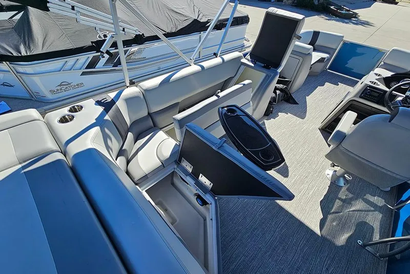 Slide: The Image of 2026 SunCatcher Select 22C pontoon boat interior with seating and storage compartments. - 11