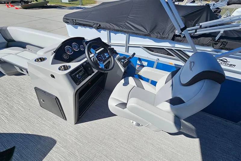 Slide: The Image of 2026 SunCatcher Select 22C boat interior with steering console and captain's chair. - 12