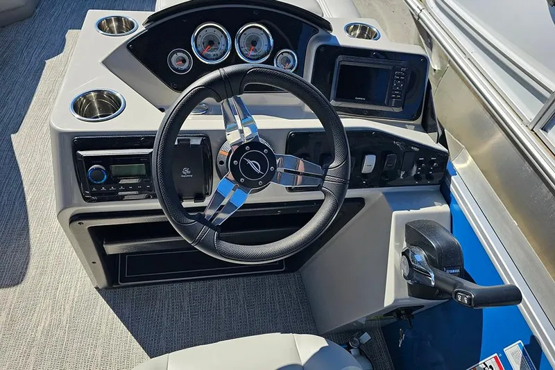Slide: The Image of Steering console of 2026 SunCatcher Select 22C boat with modern controls and gauges. - 14
