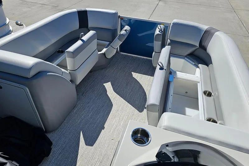 Slide: The Image of 2026 SunCatcher Select 22C pontoon boat interior with plush seating and cup holders. - 18