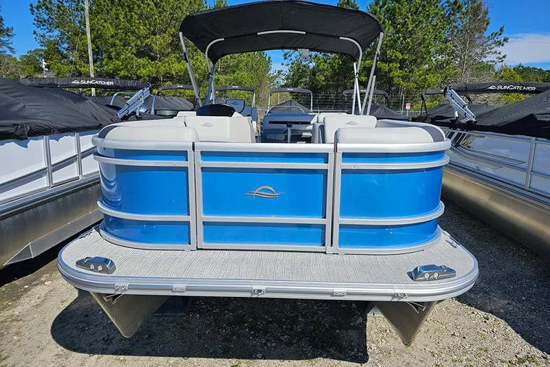 Slide: The Image of 2026 SunCatcher Select 22C pontoon boat with blue exterior, parked outdoors. - 2