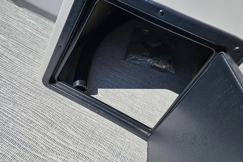 Slide: The Image of Storage compartment in 2026 SunCatcher Select 22C boat, featuring a hose and accessory bag. - 21