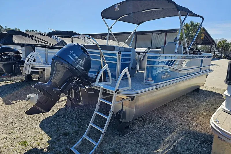 Slide: The Image of 2026 SunCatcher Select 22C pontoon boat with Yamaha outboard motor, docked outdoors. - 4
