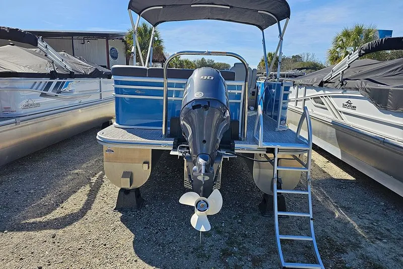 Slide: The Image of 2026 SunCatcher Select 22C pontoon boat with outboard motor, docked outdoors. - 5