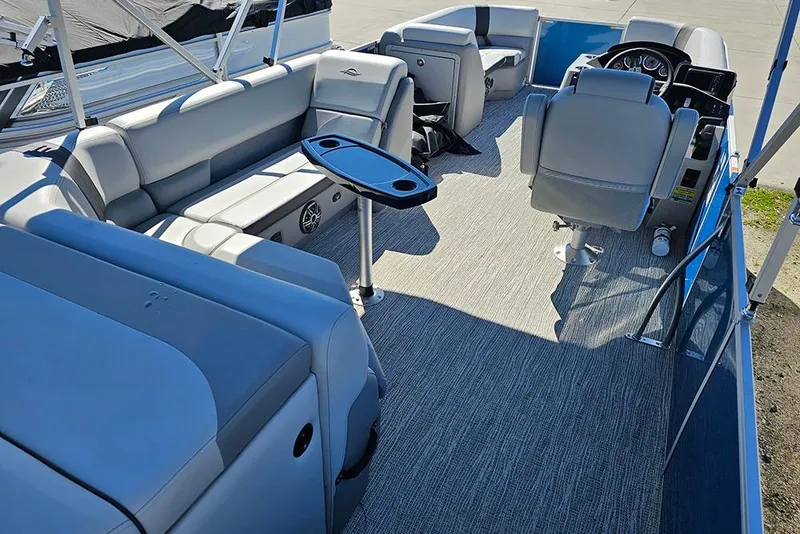 Slide: The Image of 2026 SunCatcher Select 22C pontoon boat interior with plush seating and modern helm. - 6