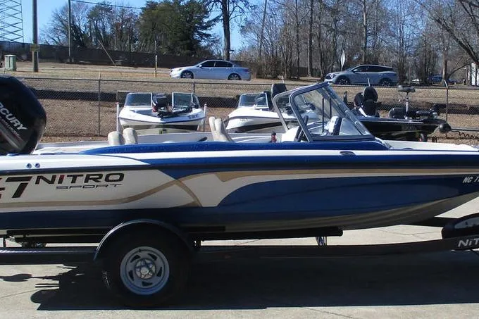 Slide: The Image of 2013 Nitro Z-7 boat on trailer, parked outdoors with other boats in the background. - 5