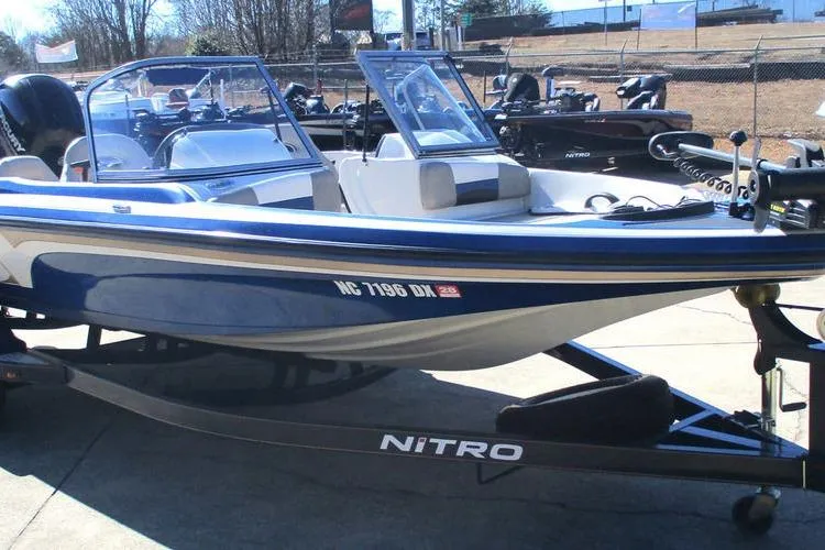 Slide: The Image of 2013 Nitro Z-7 boat on trailer, blue and white, parked outdoors. - 6