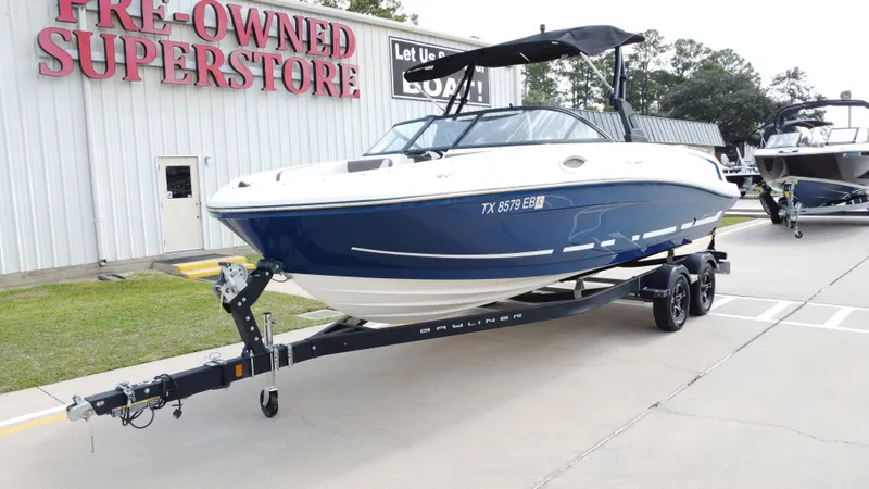 Slide: The Image of 2018 Bayliner VR6 boat on trailer in a parking lot. - 10