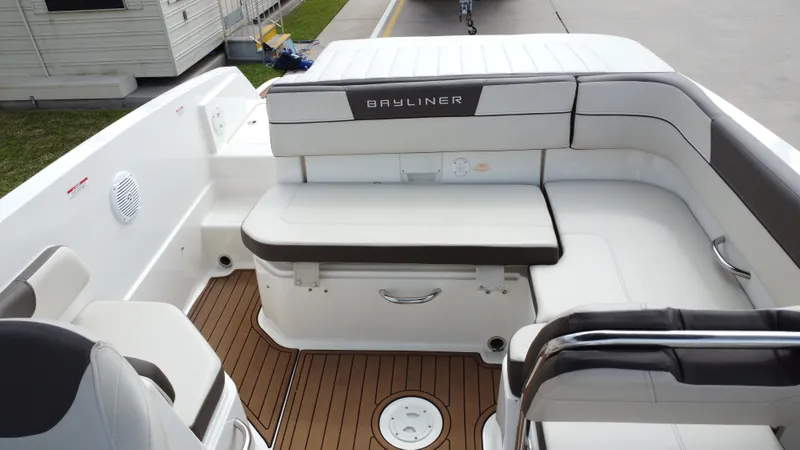 Slide: The Image of Interior of a 2018 Bayliner VR6 boat with white seating area. - 26