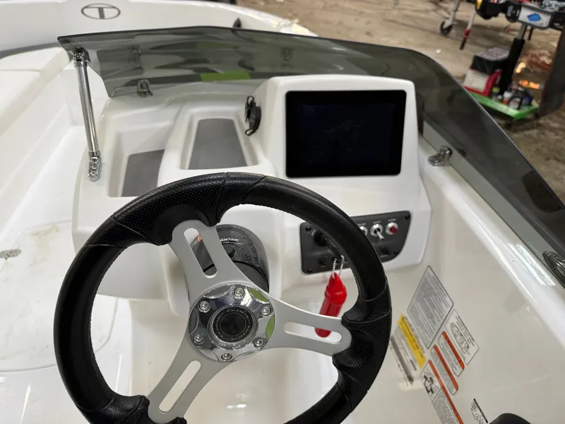 Slide: The Image of Interior view of 2024 Tahoe T16 boat cockpit with steering wheel and dashboard. - 14