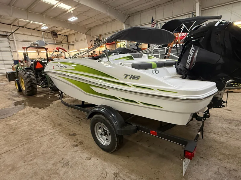 Slide: The Image of 2024 Tahoe T16 boat in a workshop, green and white accents. - 2