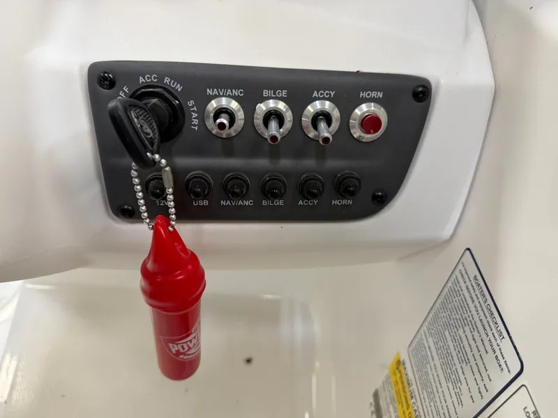 Slide: The Image of 2024 Tahoe T16 dashboard with switches and ignition key. - 23