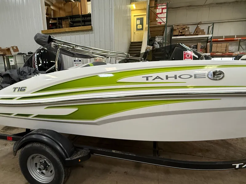 Slide: The Image of 2024 Tahoe T16 boat with green stripe in warehouse. - 5