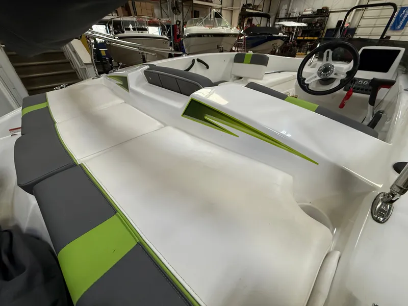 Slide: The Image of Interior of a 2024 Tahoe T16 boat with green and gray seating. - 7