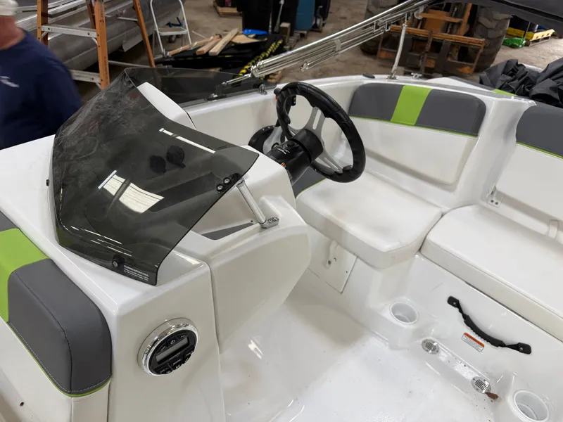 Slide: The Image of 2024 Tahoe T16 boat interior with steering wheel and seating. - 9