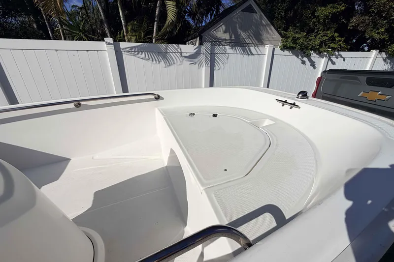 Slide: The Image of 2016 Boston Whaler 130 Super Sport boat interior with white deck and railing. - 11