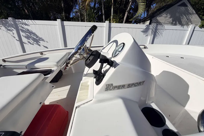 Slide: The Image of 2016 Boston Whaler 130 Super Sport boat interior with steering wheel and dashboard. - 4