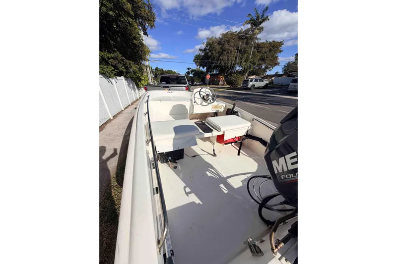 Slide: The Image of 2016 Boston Whaler 130 Super Sport boat parked on a sunny street. - 5