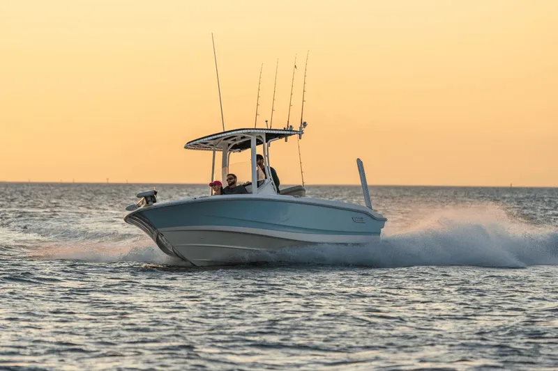 Slide: The Image of Boston Whaler 220 Dauntless 2026 on water at sunset. - 10