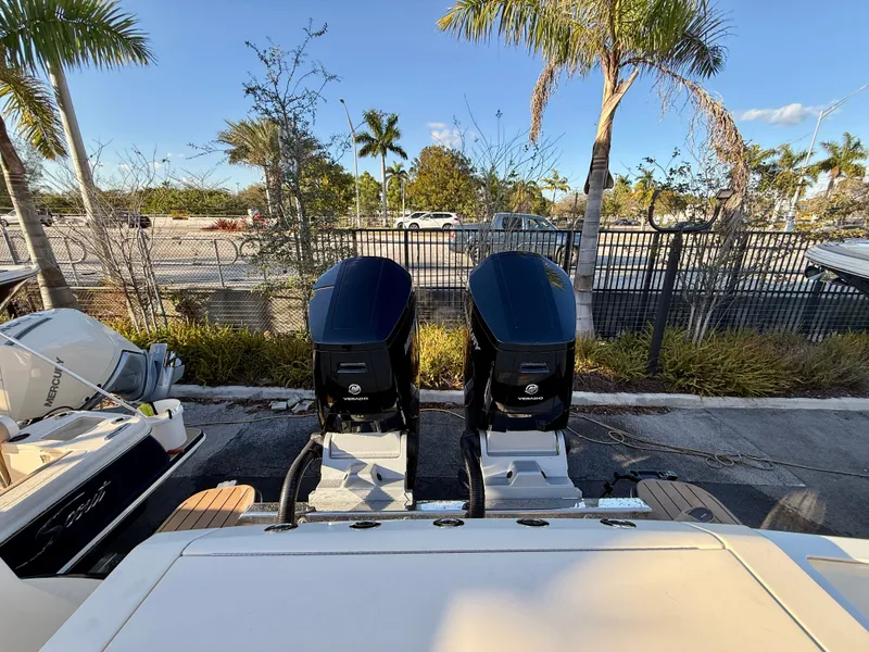 Slide: The Image of Scout 377 LXF 2023 with dual outboard engines, palm trees in background. - 17