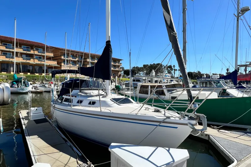 The Image of 1987 Catalina 30 MkII sailboat docked at marina with clear blue sky. - 0