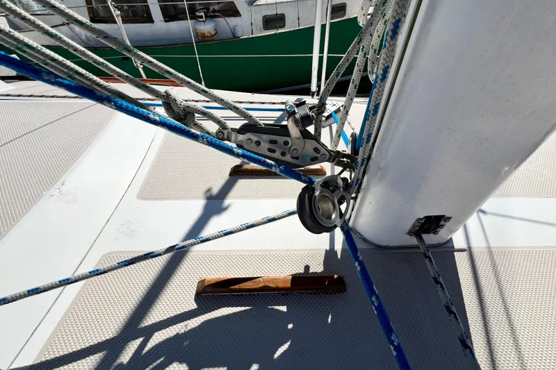 Slide: The Image of Deck rigging on a 1987 Catalina 30 MkII sailboat, featuring ropes and pulleys. - 11