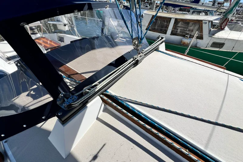 Slide: The Image of 1987 Catalina 30 MkII sailboat deck with rigging and marina view. - 12