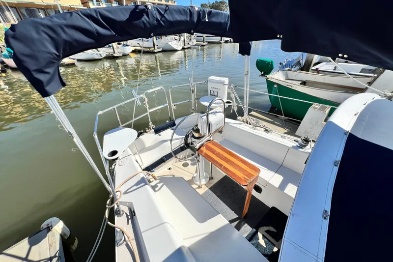Slide: The Image of 1987 Catalina 30 MkII sailboat cockpit with canopy, docked at marina. - 16