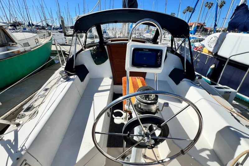 Slide: The Image of Cockpit of 1987 Catalina 30 MkII sailboat with steering wheel and navigation equipment. - 17