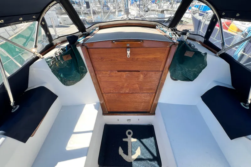 Slide: The Image of Cockpit of 1987 Catalina 30 MkII sailboat with wooden hatch and anchor-themed mat. - 21