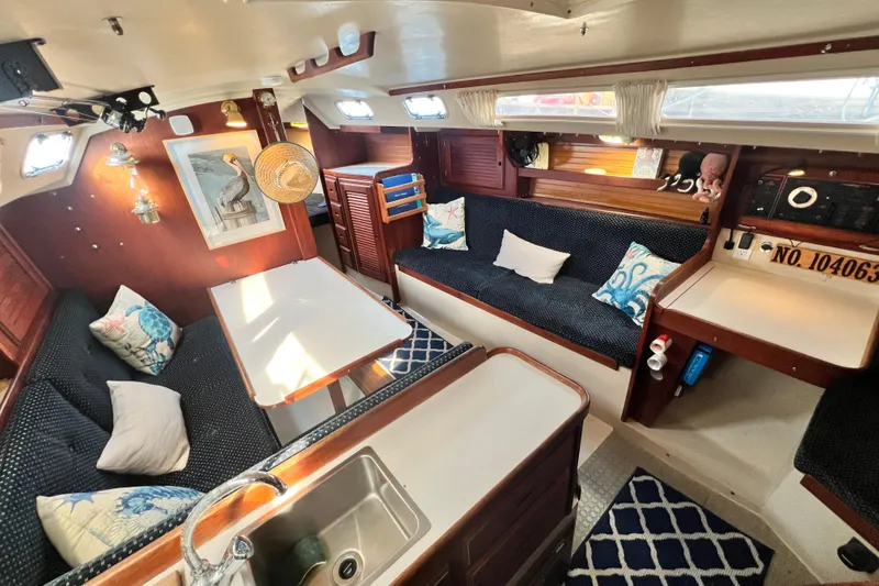 Slide: The Image of Interior of 1987 Catalina 30 MkII sailboat with cozy seating and nautical decor. - 22