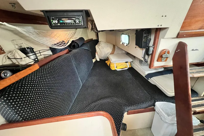 Slide: The Image of Interior of 1987 Catalina 30 MkII sailboat with cozy seating and storage. - 25