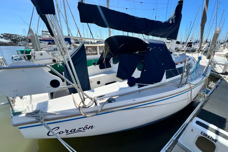 Slide: The Image of 1987 Catalina 30 MkII sailboat docked, featuring blue canvas covers and sleek design. - 3