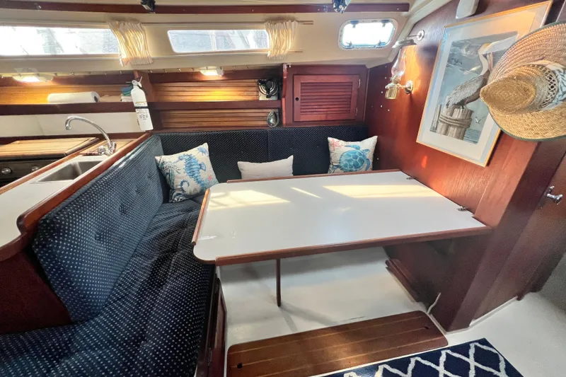 Slide: The Image of Cozy interior of 1987 Catalina 30 MkII sailboat with dining area and nautical decor. - 30