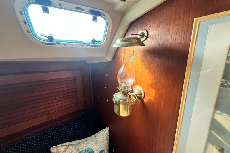 Slide: The Image of Interior of 1987 Catalina 30 MkII with brass oil lamp and wooden paneling. - 32