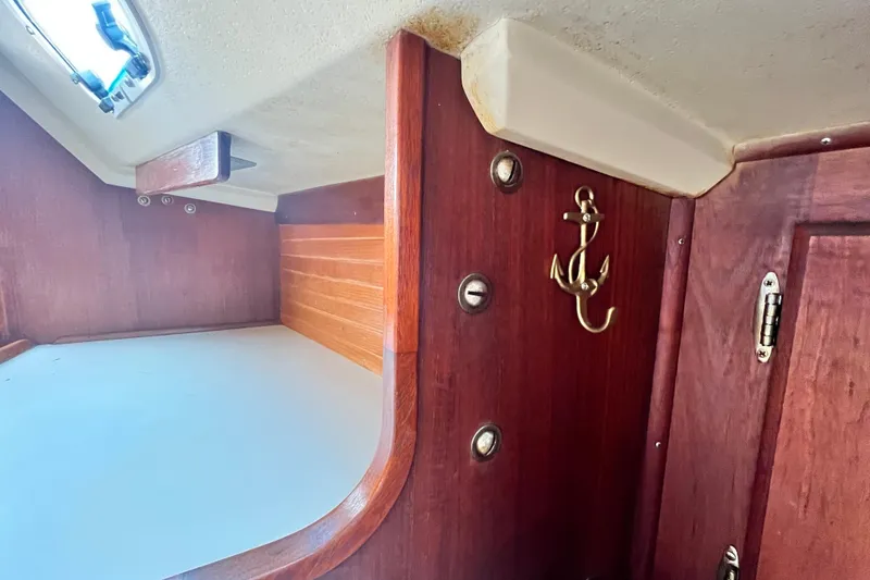 Slide: The Image of Interior of 1987 Catalina 30 MkII sailboat with wooden paneling and anchor hook. - 33