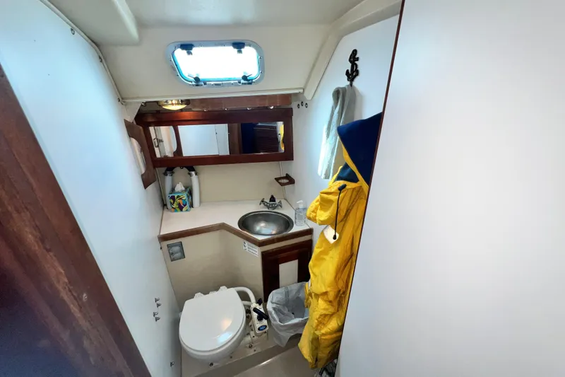 Slide: The Image of Compact bathroom in 1987 Catalina 30 MkII sailboat with sink, toilet, and storage. - 34